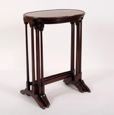 A nest of three oval tables on