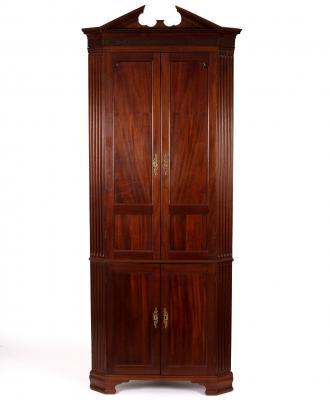 A mahogany corner cupboard with broken