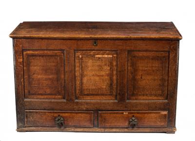 An oak chest with panelled front,