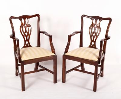 A pair of Georgian style open armchairs