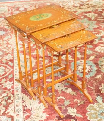 A nest of three satinwood tables, with