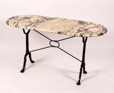 A marble top table on cast iron