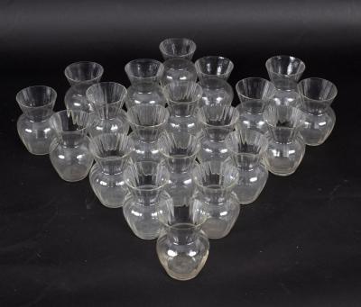 Twenty small glass posy vases with