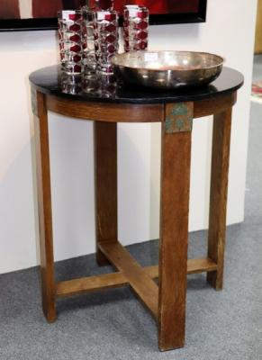 A circular 1940s oak table, label