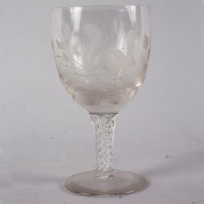 A wine glass etched a squirrel, on an