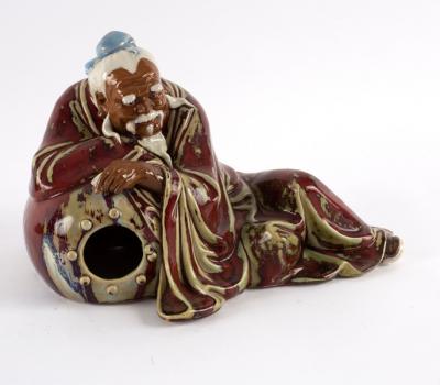 A Chinese pottery figure by Liu