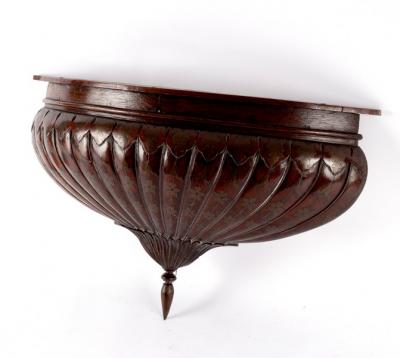 A carved walnut canopy finial of