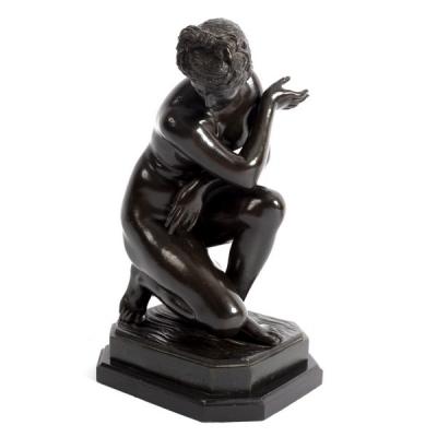 A bronze figure of a nude, on a
