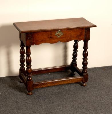 An oak table with shaped frieze