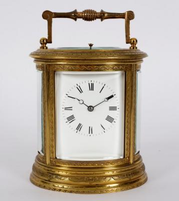 A gilt brass carriage clock in an oval