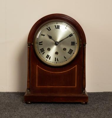 A mahogany arch-top mantel clock