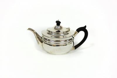 A silver teapot, London 1911, of oval
