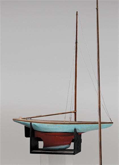 Painted pond model of a sail boat