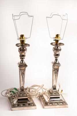 A pair of silver plated candlesticks,