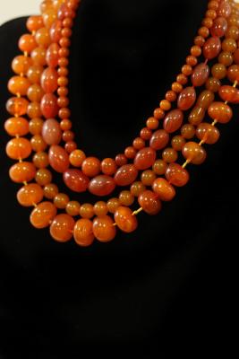 Three amber bead necklaces and an agate