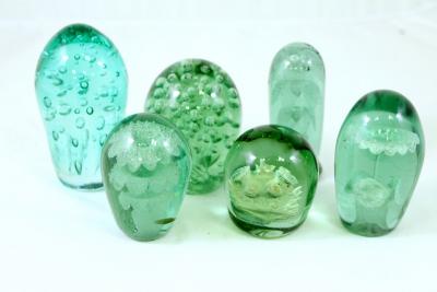 Six green glass dumps, the largest 14.5cm