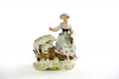 A Meissen group of a girl and sheep,