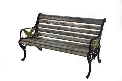 A slatted garden bench, the iron end