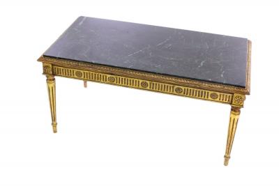 A marble top coffee table on fluted