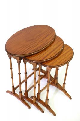 A nest of three oval satinwood tables,