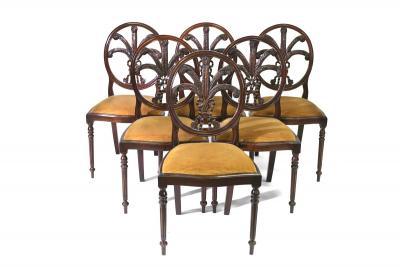 A set of six dining chairs, each with