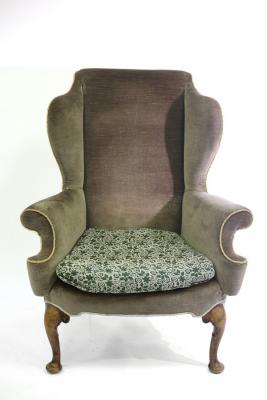 An 18th Century style wingback armchair