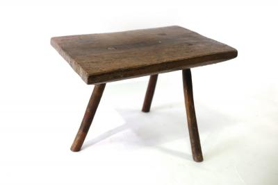 A primitive three-legged stool/table,