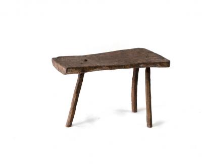 A primitive three-legged stool,