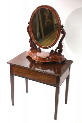 A mahogany table with hinged lid,
