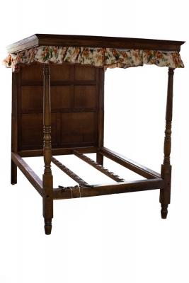 An oak tester bed with panelled