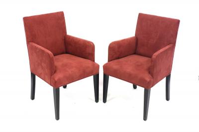 A pair of modern armchairs upholstered