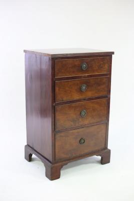 A narrow mahogany chest of four drawers,
