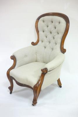 A Victorian button back armchair with