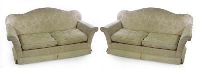 A pair of two-seater sofas upholstered