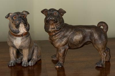 Two painted pottery figures of pugs,
