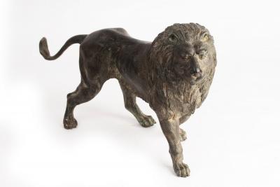 A bronze figure of a standing lion,