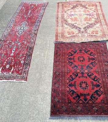 A Pakistan red ground rug with