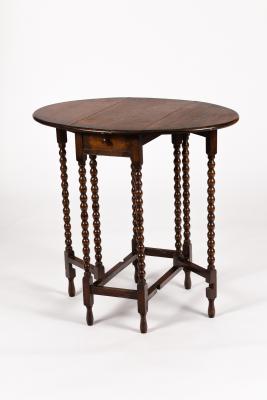 An oval two-flap gateleg table on slender