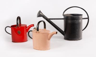 Three painted watering cans