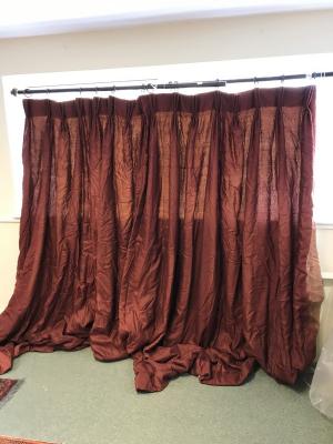A pair of dark red silk curtains