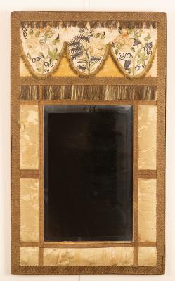 A wall mirror with a surround of 2dcd51