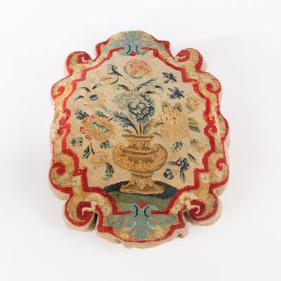 A cushion with a tapestry fragment