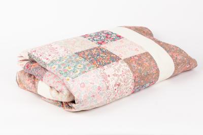 A patchwork quilt of square floral 2dcdef