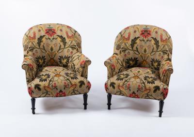 A pair of upholstered tub shaped armchairs,