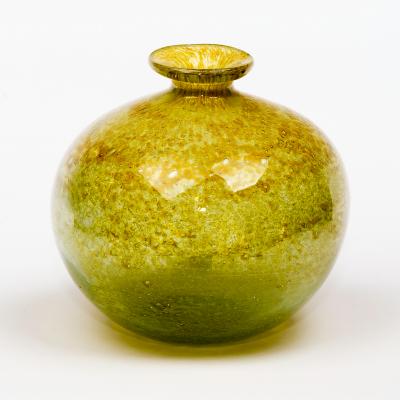 A yellow art glass vase of globular