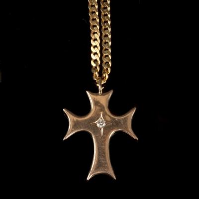 A gold cross centred by a diamond of