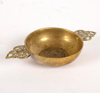 A small brass porringer with pierced