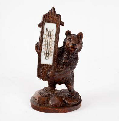 A Black Forest carved thermometer