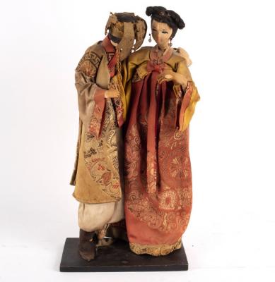 Two Japanese composition dolls in brocade