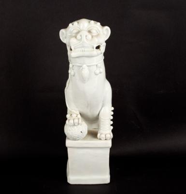 A blanc-de-chine figure of a dog of